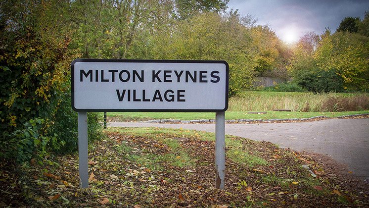 Photograph of the sign post as you enter Milton Keynes Village